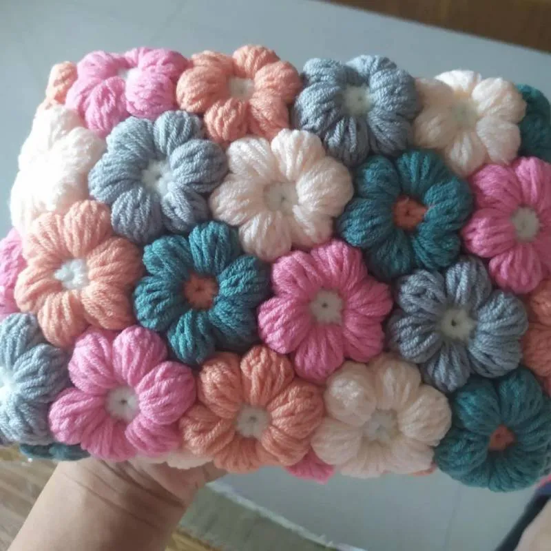 Hand woven woolen bag with puff flowers