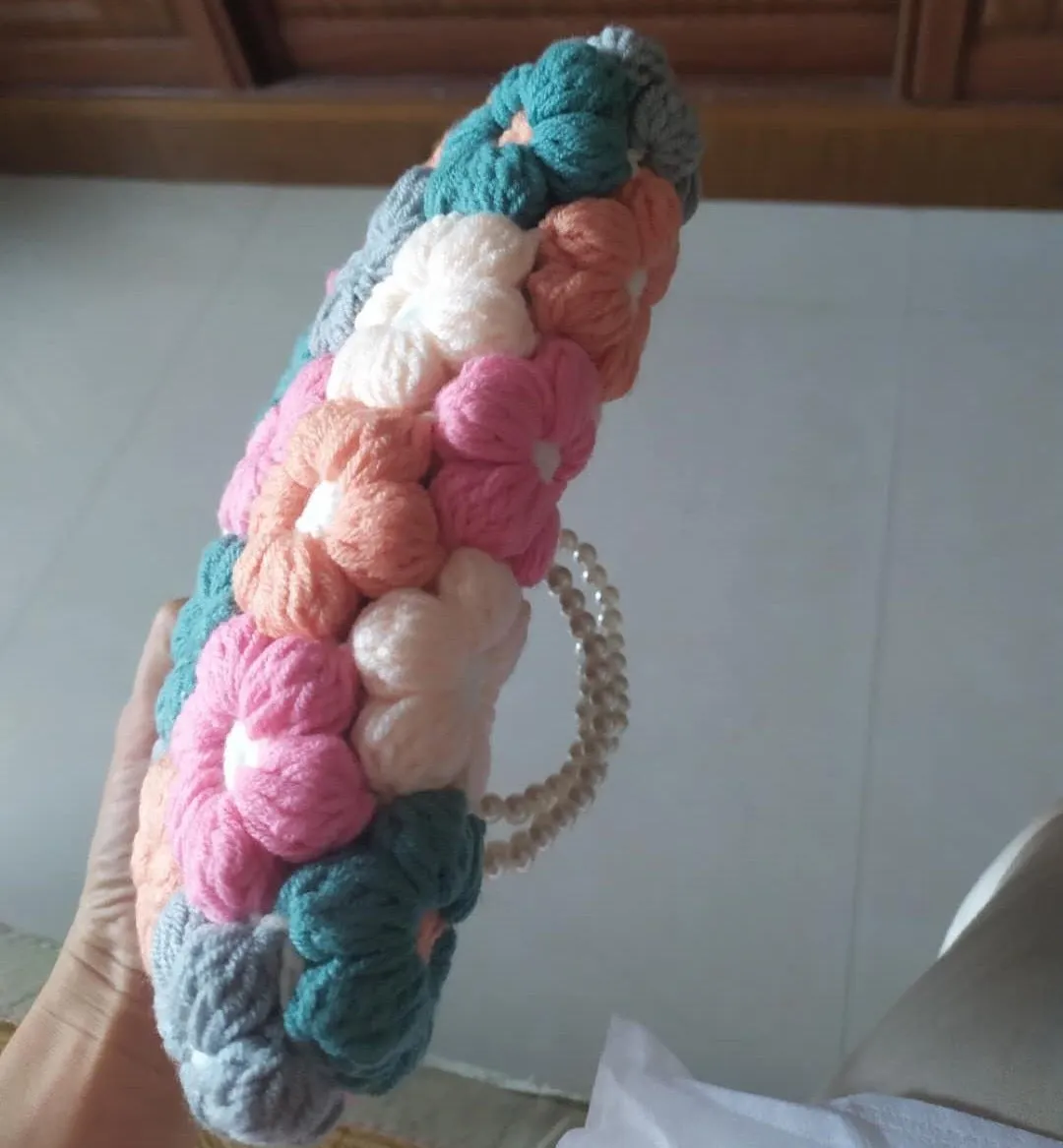 Hand woven woolen bag with puff flowers