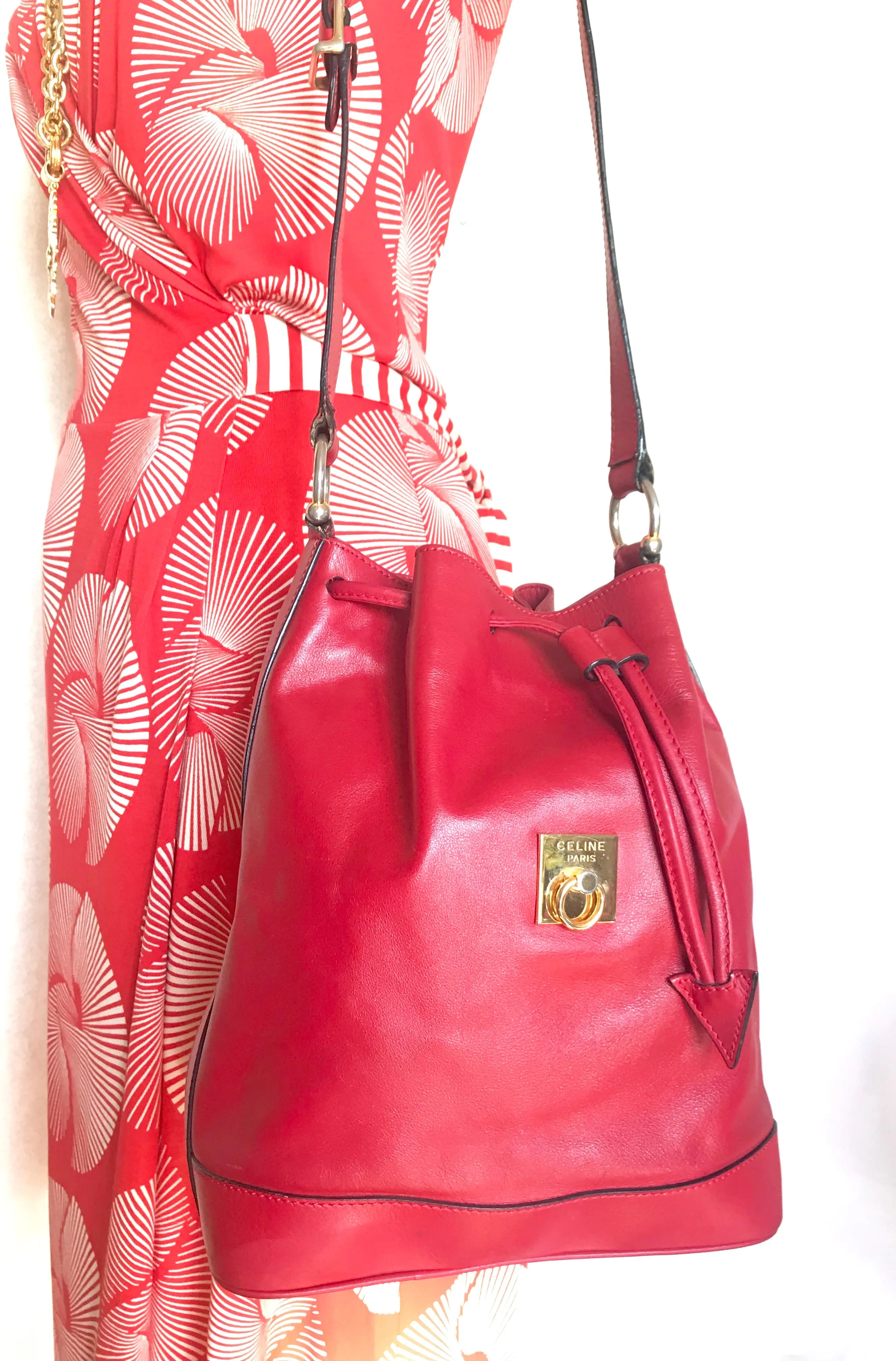 Vintage Celine red leather hobo bucket shoulder bag with a golden square logo motif and matching pouch. Classic drawstrings purse.