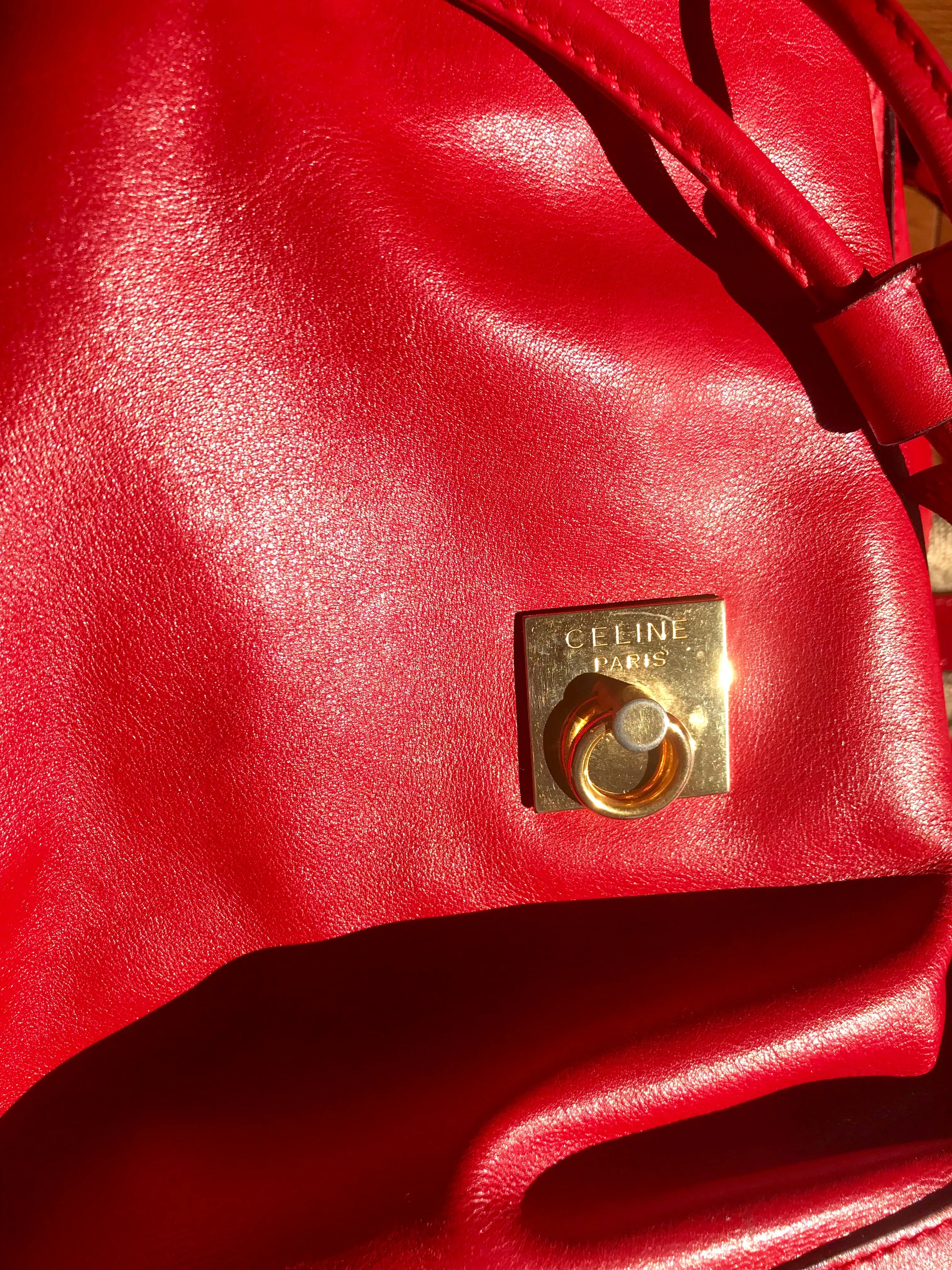 Vintage Celine red leather hobo bucket shoulder bag with a golden square logo motif and matching pouch. Classic drawstrings purse.