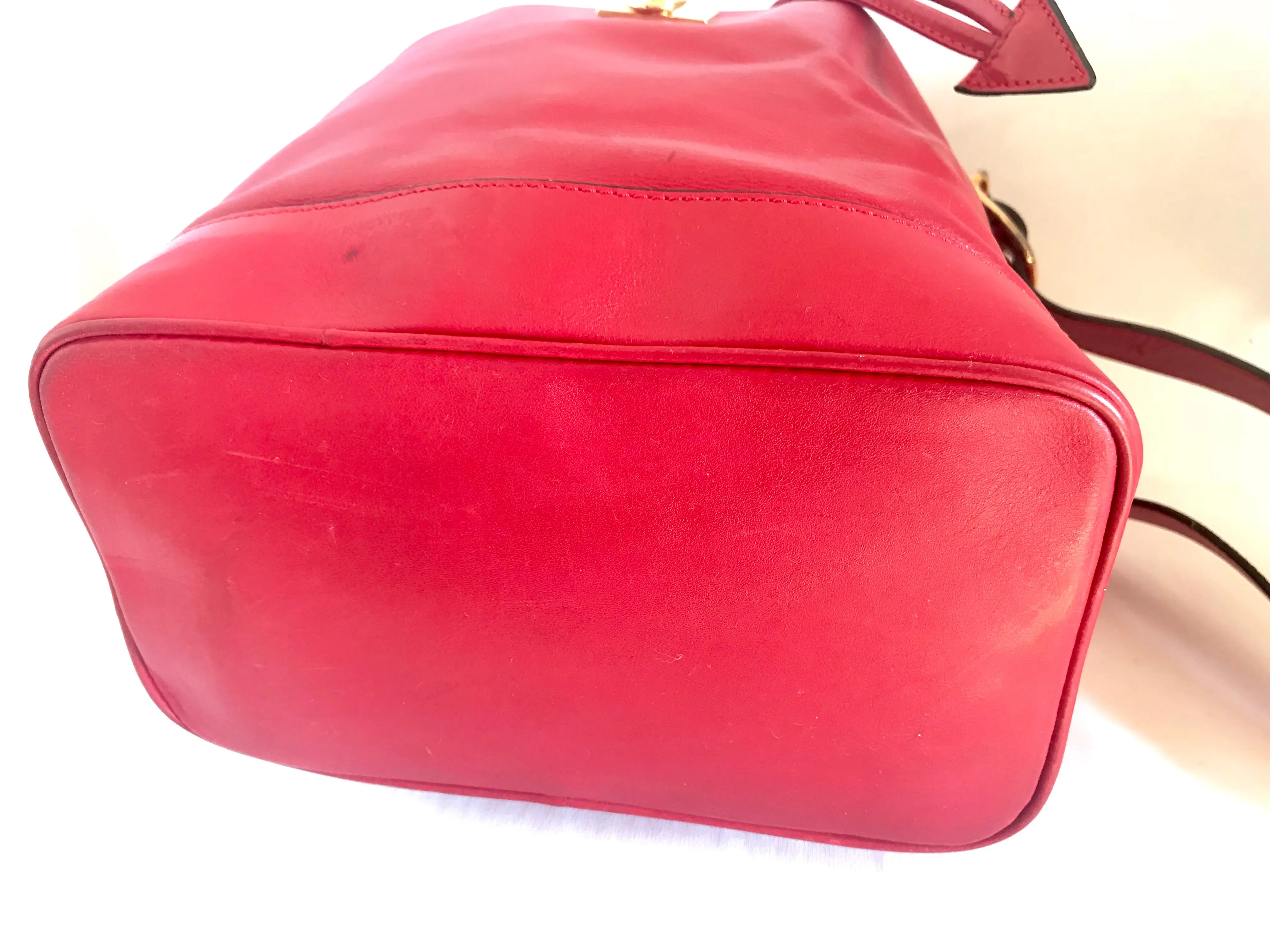 Vintage Celine red leather hobo bucket shoulder bag with a golden square logo motif and matching pouch. Classic drawstrings purse.