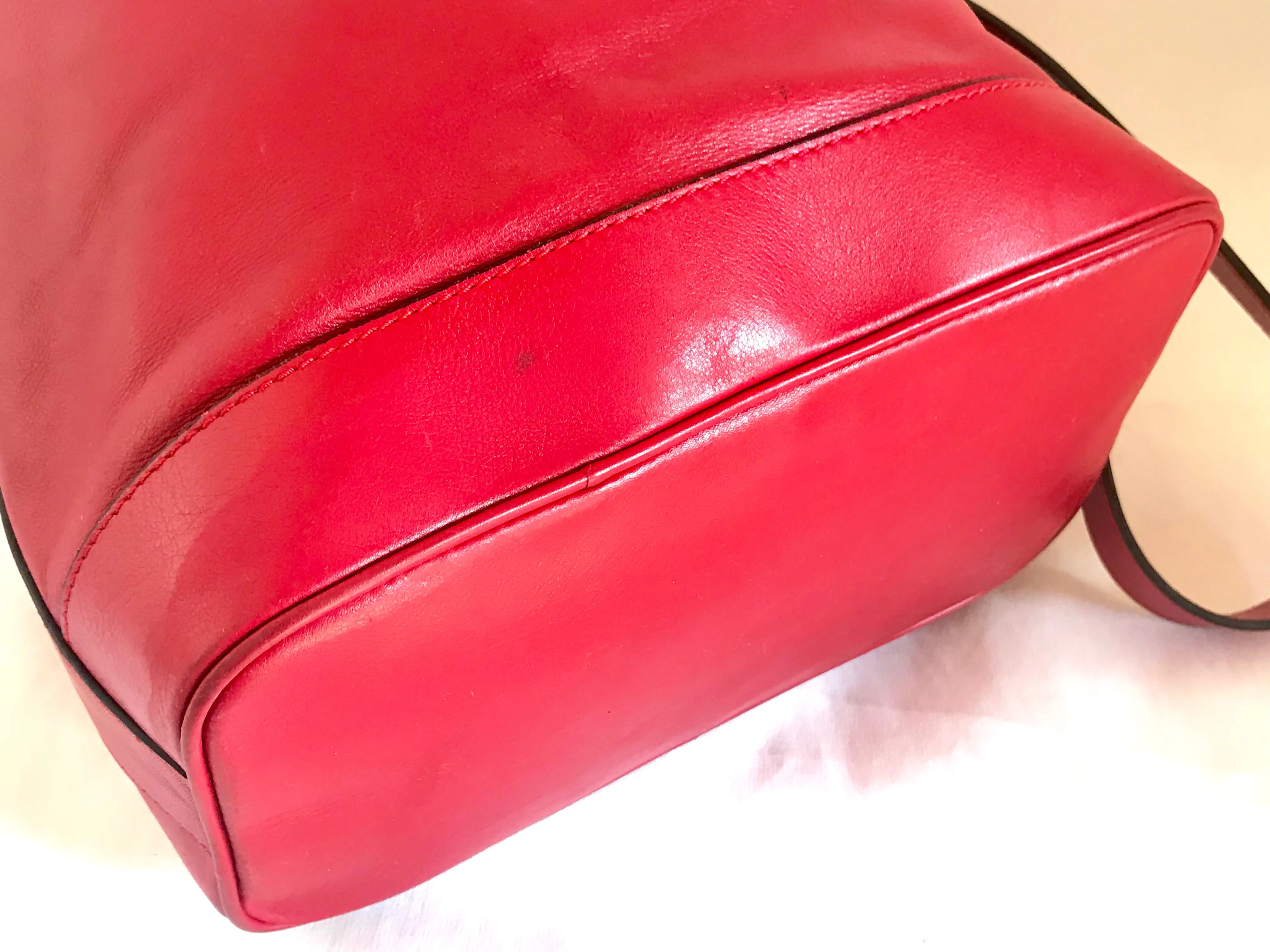 Vintage Celine red leather hobo bucket shoulder bag with a golden square logo motif and matching pouch. Classic drawstrings purse.