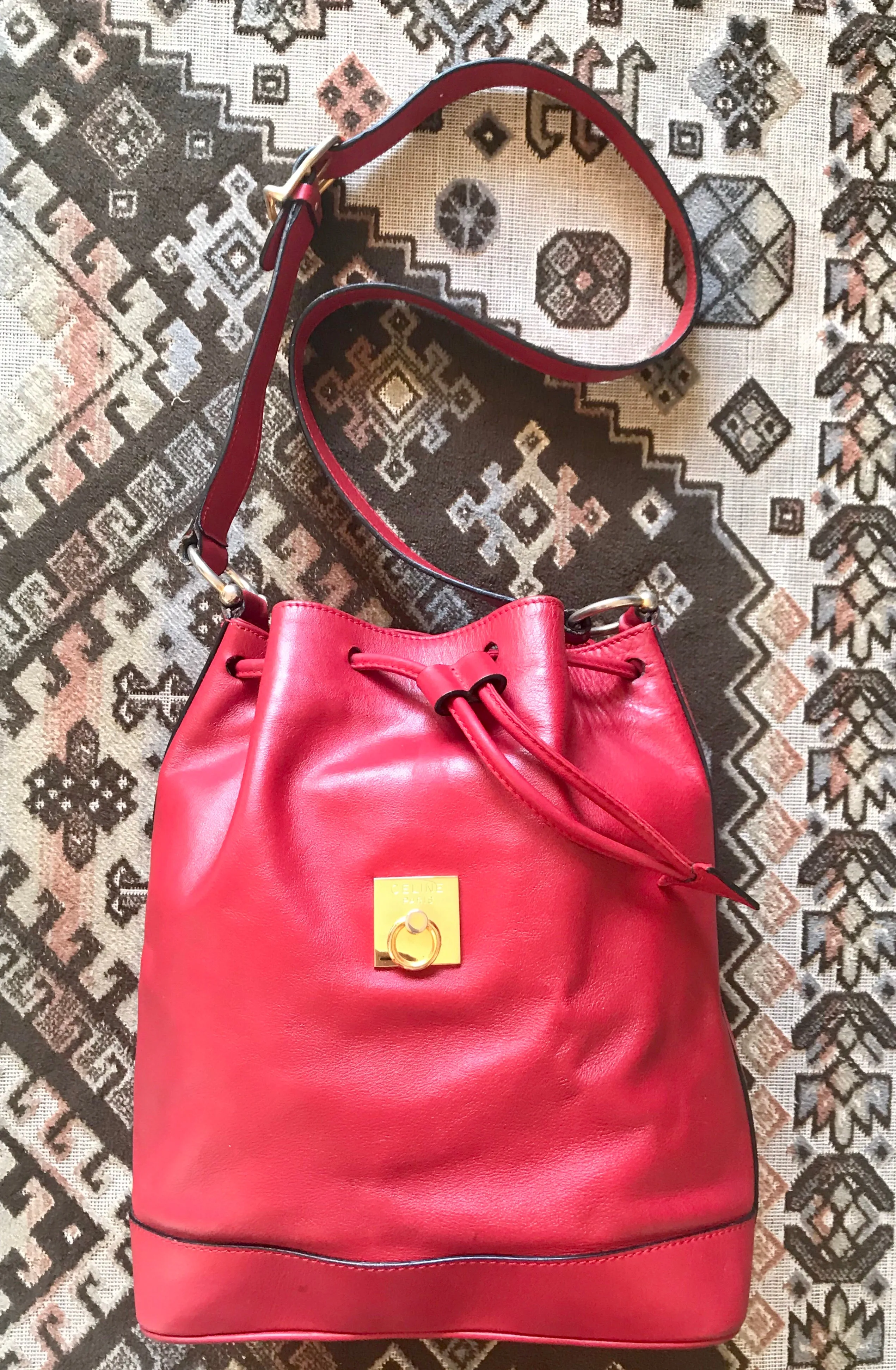 Vintage Celine red leather hobo bucket shoulder bag with a golden square logo motif and matching pouch. Classic drawstrings purse.